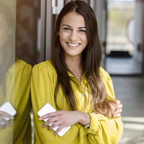 Portrait of young businesswoman in office atrium